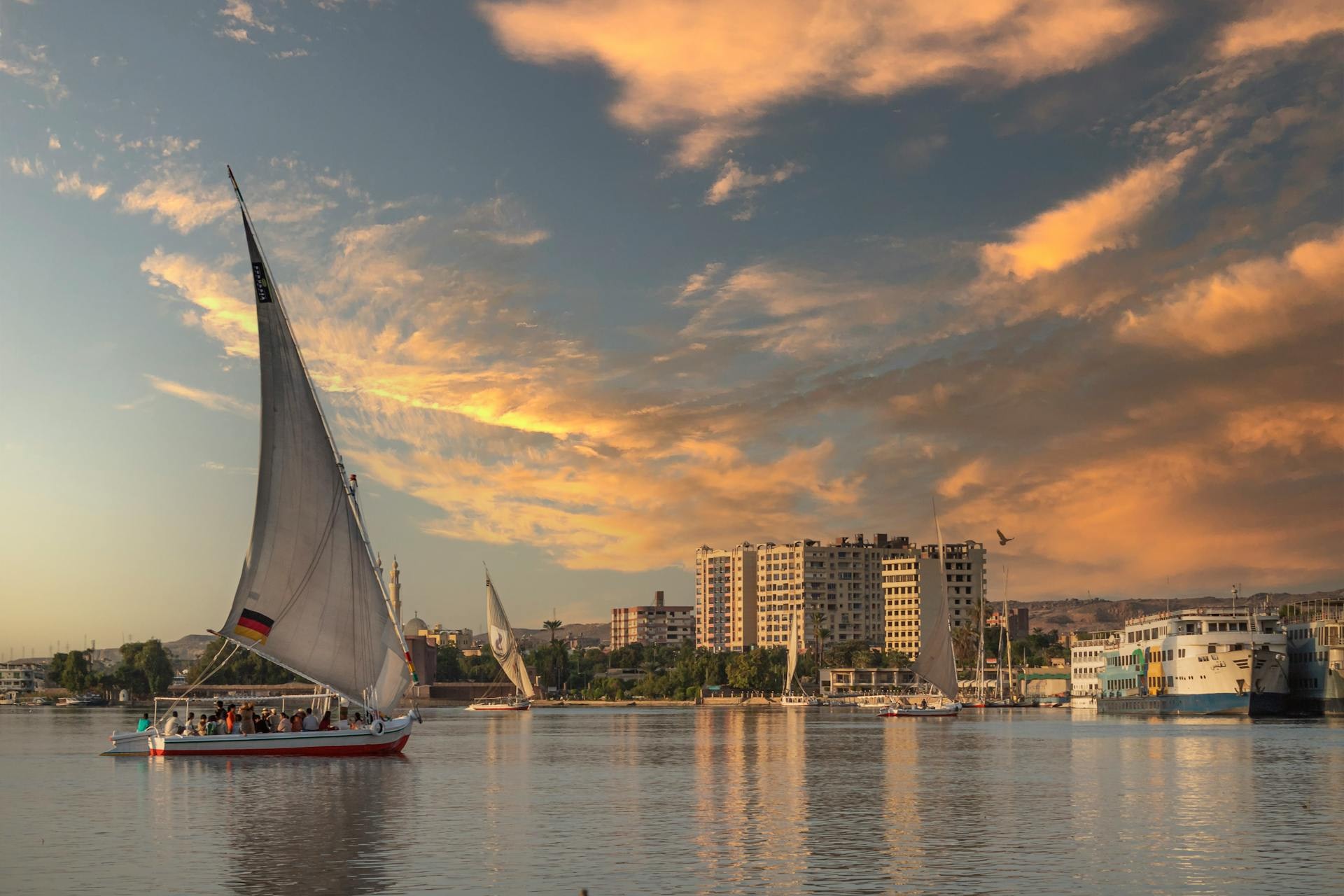 Felucca sailing past the temple of Kom Ombo on the Nile at sunset