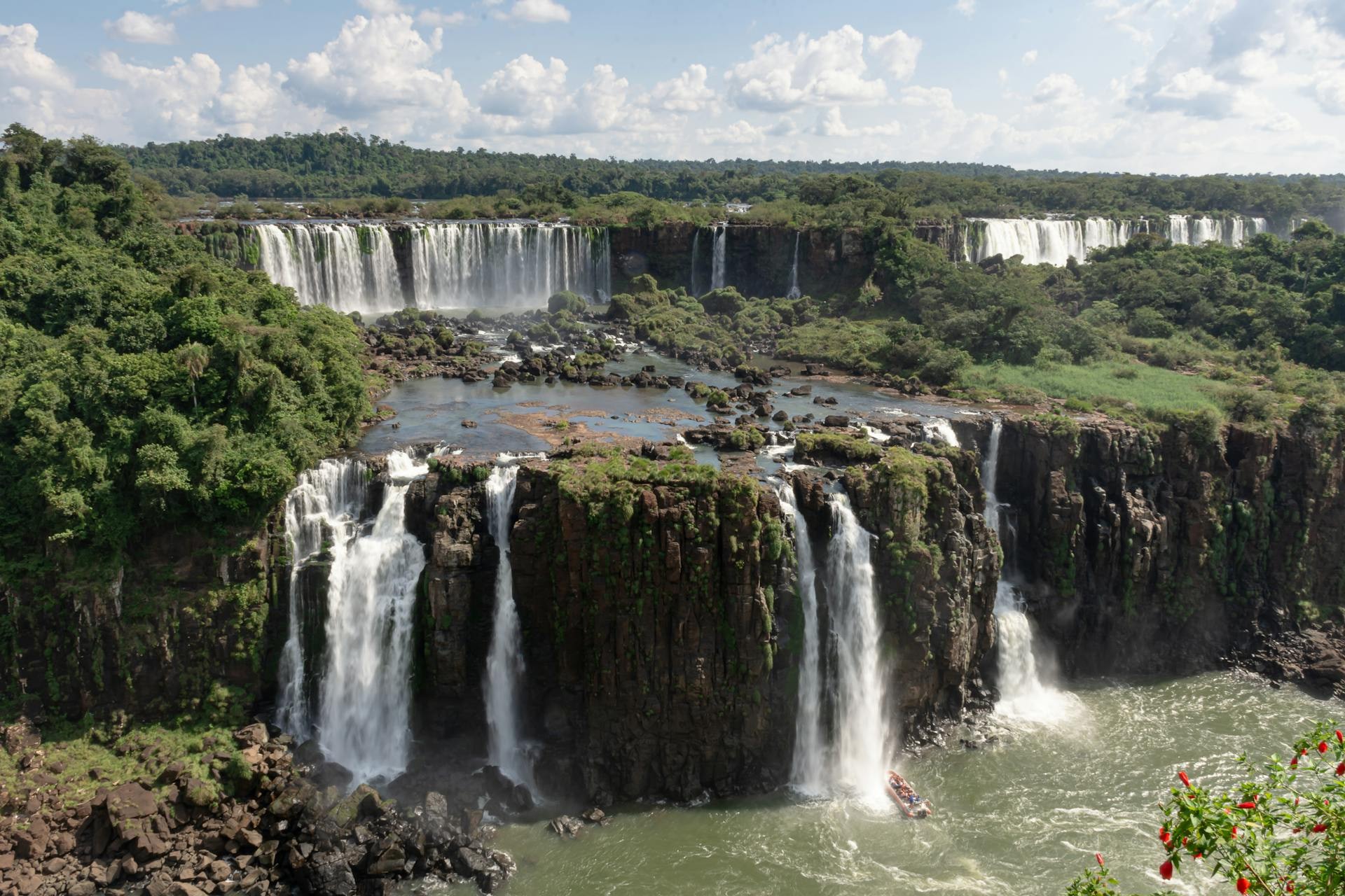Cascades of Iguazu Falls thundering through subtropical rainforest on the Brazil–Argentina border