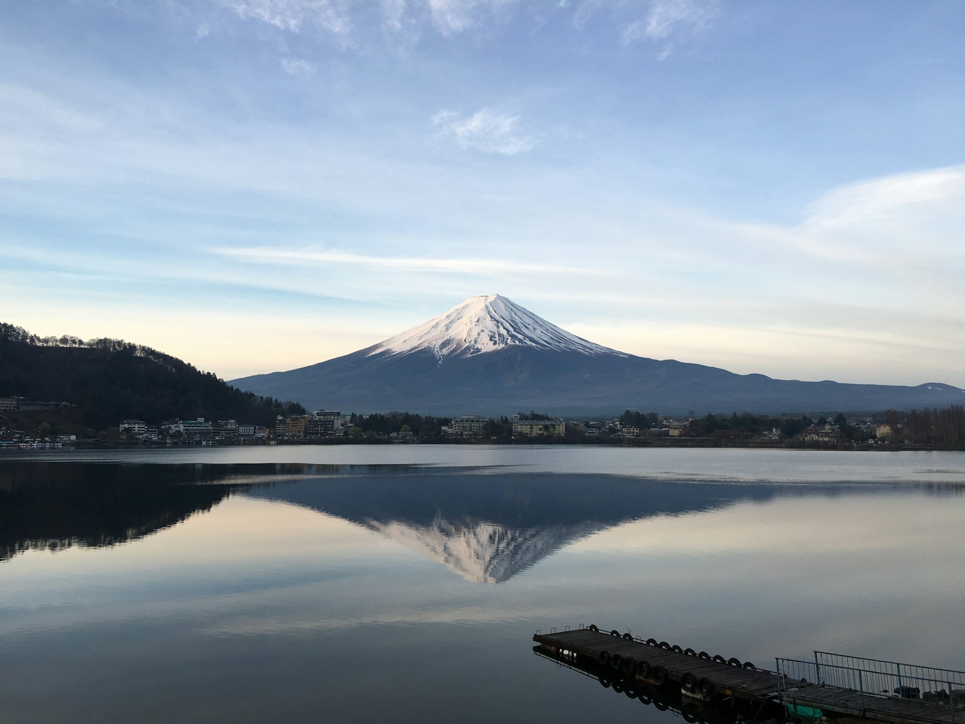 Mount Fuji at dawn with climbers on the upper switchbacks above the cloud line